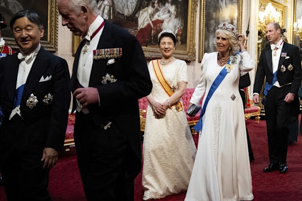 Britain's King Charles III, Emperor Naruhito, left, Empress Masako and Queen Camilla, right, make their way along the East Gallery to attend the State Banquet in London, Tuesday, June 25, 2024, during the State Visit of the Japanese Emperor and Empress to Britain. (Aaron Chown/Pool via AP)