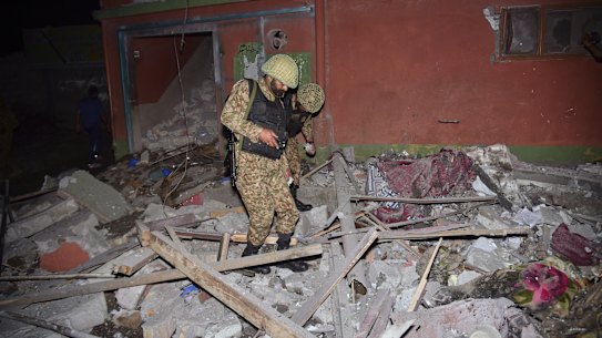 Army soldiers examine a building damaged by a suspected Indian missile attack near Muzaffarabad, the capital of Pakistan controlled Kashmir, Wednesday, May 7, 2025. (AP Photo/M.D. Mughal)