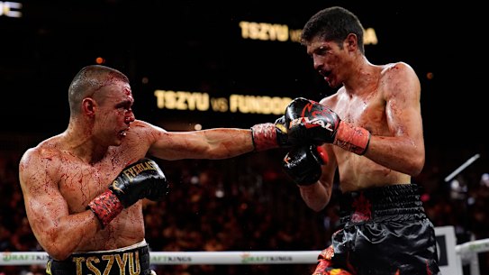A bloodied Tim Tszyu after catching Sebastian Fundora’s elbow early in their world title bout.
