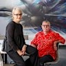 Sandra Powell and Andrew King sit in front of their full-wall Kid Zoom mural, among just a few of the many other works in their collection.
