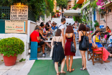 Crowds throng the eateries and bars in the old district of Plaka.