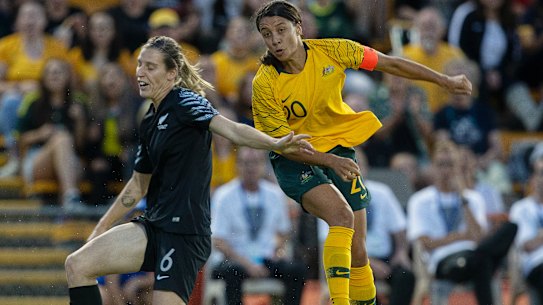 Football Ferns star Rebekah Stott blocks a shot from Matildas skipper Sam Kerr.