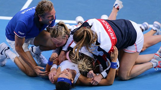True Blues: A delighted French team celebrate after Caroline Garcia and Kristina Mladenovic won the deciding doubles match against Australia's Ashleigh Barty and Samantha Stosur.