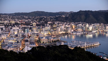 Buildings stand illuminated at dawn in Wellington, New Zealand.
