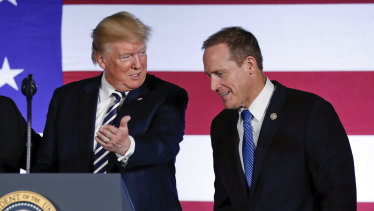 US President Donald Trump offers the podium to North Carolina congressman Ted Budd, who ran in a district intentionally drawn to favour Republicans.  