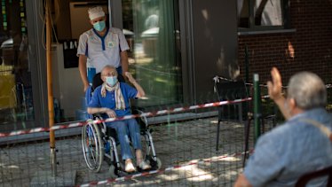 Liliana Van Dyck, 85, says goodbye to her son, Marc, at the end of his visit during a partial lockdown at the Les Jardin D'astrid rest home in Maurage, Belgium.