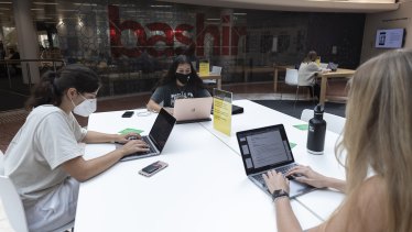 Women wear masks indoors at the State Library in Sydney on January 3.
