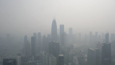 The Petronas Twin Towers, centre, and other buildings stand shrouded in haze in Kuala Lumpur, Malaysia, on Wednesday,