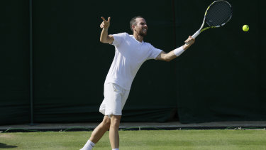 Adrian Mannarino of France returns a ball at Wimbledon. 