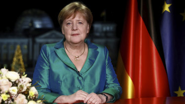 German Chancellor Angela Merkel poses for media after the recording of her annual New Year's speech at the Chancellery in Berlin.