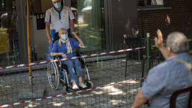 Liliana Van Dyck, 85, says goodbye to her son, Marc, at the end of his visit during a partial lockdown at the Les Jardin D'astrid rest home in Maurage, Belgium.