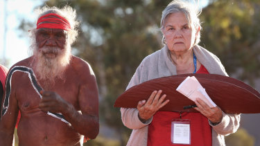 Mutitjulu elder Rolley Mintuma joins Pat Anderson as she carries the Uluru Statement from the Heart last year. 