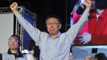 Re-elected Taipei city mayor  Ko Wen-je celebrates his victory with supporters in Taipei, Taiwan, early on Sunday.