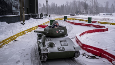 Visitors drive a model of a Soviet era T-34 tank at the Tankodrom children’s adventure attraction at Patriot Park outside the Cathedral of Russian Armed Forces in Kubinka, Russia.