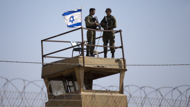 Israeli soldiers keep watch over the Israel-Gaza Strip border, where almost 60 Palestinians were shot and killed and 1360 injured this week. 