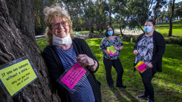 Lee Smith-Moir and daughters Tai (centre) and Cassie with her feel-good messages at Cruickshank Park in Yarraville. 