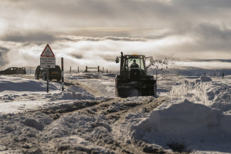 Snow is cleared from the Buttertubs Pass in North Yorkshire, England, on Sunday.