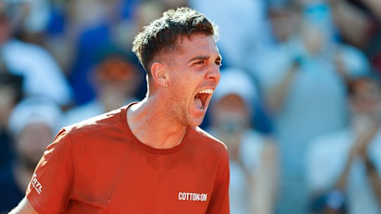 Thanasi Kokkinakis celebrates after defeating Stan Wawrinka in the second round of the French Open.