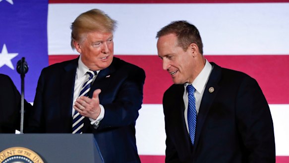 US President Donald Trump offers the podium to North Carolina congressman Ted Budd, who ran in a district intentionally drawn to favour Republicans.  