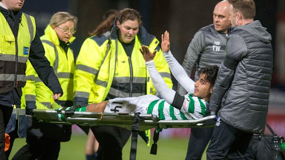 Optimistic: Daniel Arzani signals to the crowd following his knee injury on his Celtic debut.