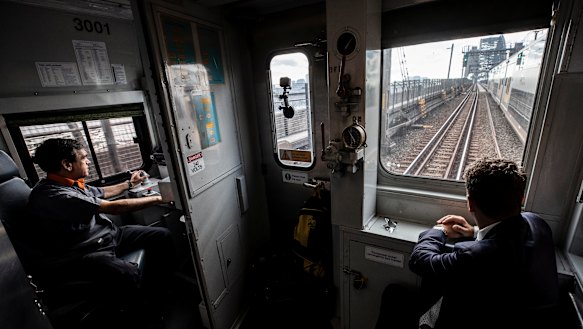 Driver Vince Vassiliou and Transport Minister Andrew Constance on S-Set 3001 as it passes over Sydney Harbour Bridge on Thursday. 