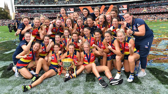 The Crows celebrate with the premiership cup.