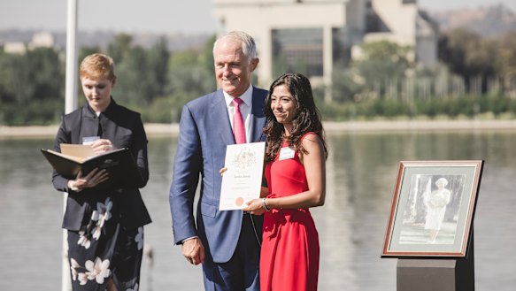 Former Prime Minister Malcolm Turnbull presents Daisy Jose with her Australian Citizenship.