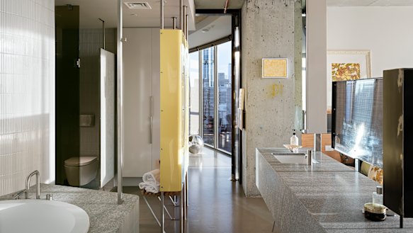 Two bedrooms were merged into the main suite and a stone vanity installed to create privacy between the bedroom and bathroom.