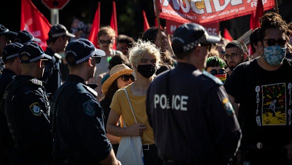 Police watch on at the deaths in custody rally on Saturday.