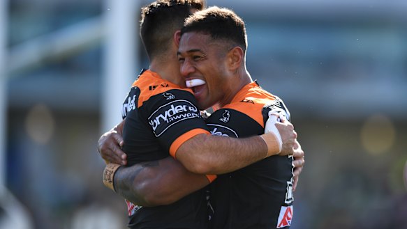 Michael Chee Kam of the Wests Tigers celebrates after scoring a try.