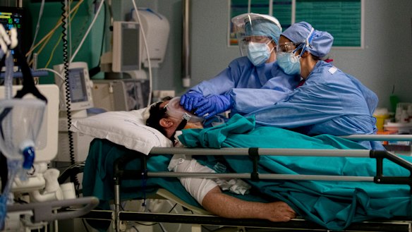 Staff tend to a patient in the emergency COVID-19 ward at the San Carlo Hospital in Milan, Italy.