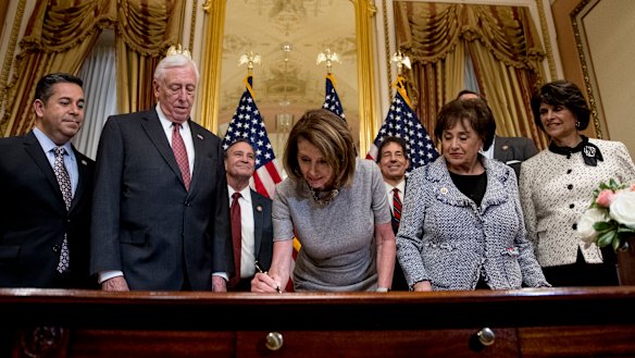 House Speaker Nancy Pelosi signs a deal to reopen the government.