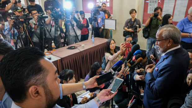 Muhammad Shafee Abdullah, lead lawyer for former Malaysia prime minister Najib Razak, right, speaks to media outside court on Wednesday.