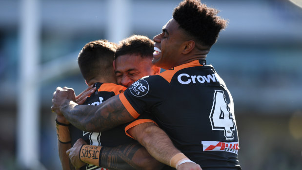 Michael Chee Kam of the Wests Tigers celebrates after scoring a try.