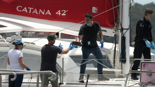 Police remove cocaine off the yacht at Lake Macquarie in November 2017.