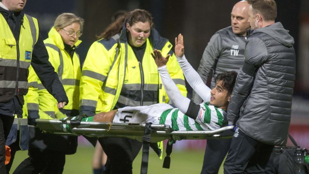 Optimistic: Daniel Arzani signals to the crowd following his knee injury on his Celtic debut.