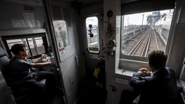 Driver Vince Vassiliou and Transport Minister Andrew Constance on S-Set 3001 as it passes over Sydney Harbour Bridge on Thursday. 