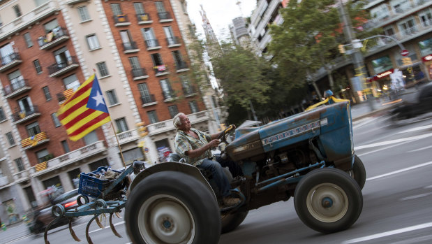 A man drives a tractor decorated with a pro-Independence flag during the Catalan National Day on Tuesday.
