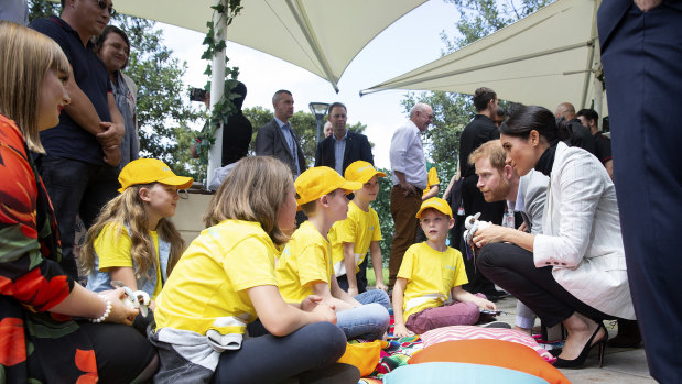 Britain's Prince Harry and his wife Meghan, the Duchess of Sussex meet children from Australian Kookaburra Kids Foundation while attending a lunchtime Reception hosted by Australian Prime Minister Scott Morrison with Invictus Games competitors and representatives of the community in the city's central parkland, The Domain (
