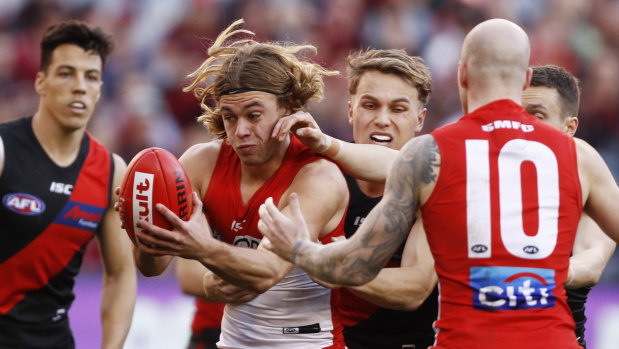 Crowded: James Rowbottom of the Swans, playing in just his fifth game, is tackled by Dylan Clarke at the MCG.