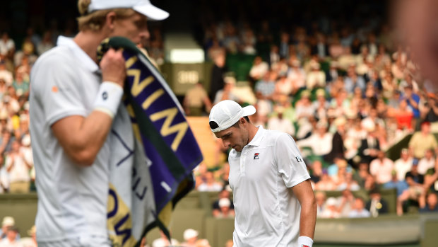 Kevin Anderson, left, and John Isner change ends during their semi-final match at Wimbledon this year.