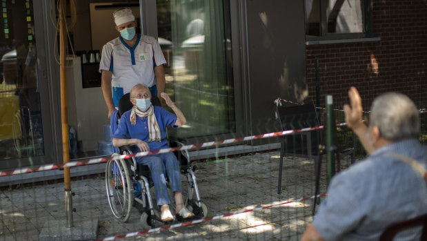 Liliana Van Dyck, 85, says goodbye to her son, Marc, at the end of his visit during a partial lockdown at the Les Jardin D'astrid rest home in Maurage, Belgium.