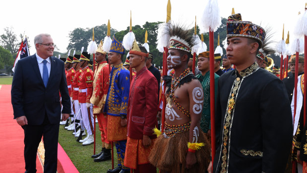 Scott Morrison inspects a guard of honour at Bogor Presidential Palace near Jakarta on Friday.