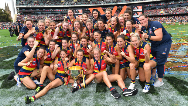 The Crows celebrate with the premiership cup.