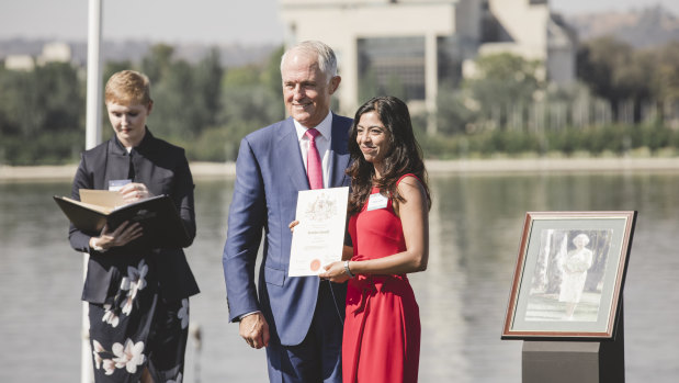 Former Prime Minister Malcolm Turnbull presents Daisy Jose with her Australian Citizenship.