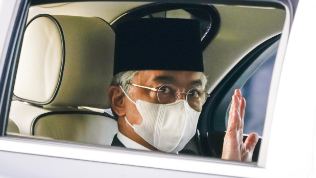 Malaysia's King Sultan Abdullah Sultan Ahmad Shah waves as he leaves National Palace in Kuala Lumpur on Sunday.