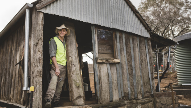 Traditional bush craftsman Myles Gostelow outside a slab shed that he is restoring on the site of the historic Blundell's Cottage.