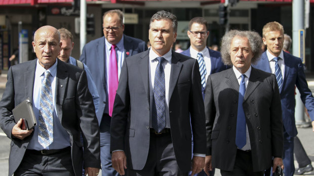 Dreamworld CEO Craig Davidson (centre) arrives with lawyers to the pre-inquest hearing into the fatal accident at the Dreamworld theme park.