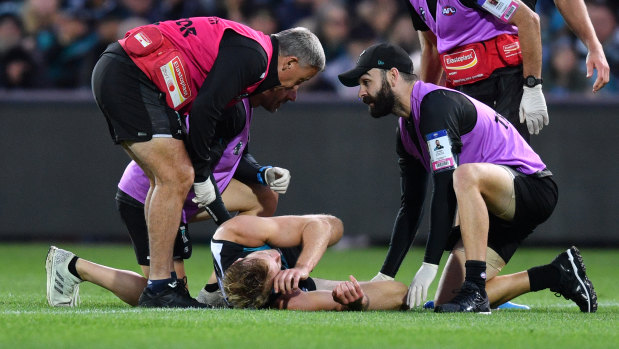 Port Power's Jack Watts is seen to by medics.