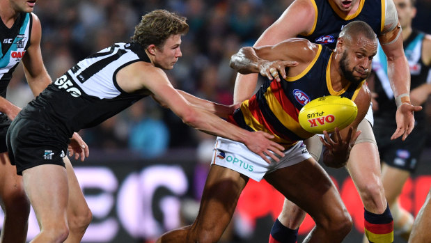 Xavier Duursma (left) lays a tackle for Port Adelaide.